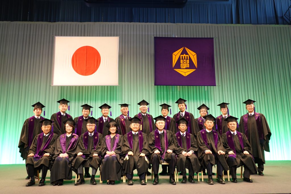 President and　university executives celebrating while wearing Gunma University-themed ties and handkerchiefs